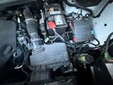 a picture of a car ' s engine with its hood open