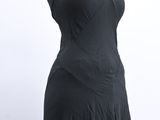black dress on a mannequin stand on a white background