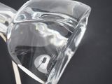 a clear glass vase with a bird inside of it