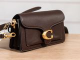 a small brown purse with a gold clasp on it