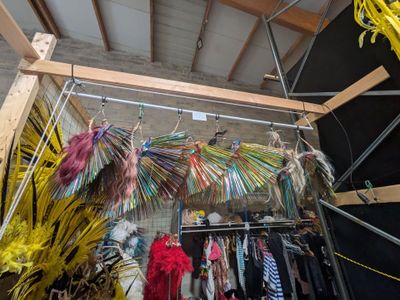 a room with a lot of clothes hanging from the ceiling