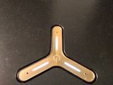 a metal object on a table with a black surface