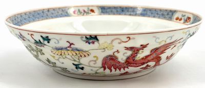 a bowl with a dragon on it on a white surface