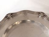 a silver plate with a decorative design on it