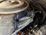 a close up of a car ' s engine with the hood open