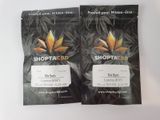 two bags of marijuana seeds sitting on top of a white table