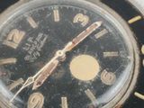 a watch that is sitting on a white surface