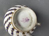 a cup and saucer sitting on top of a saucer