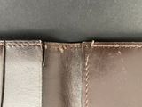the inside of a wallet with a small hole in the middle of it