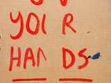 a cardboard sign that says blood over you ' re hands