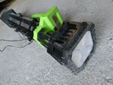un ventilateur vert et noir posé par terre