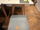 a desk with a chair and a laptop on it