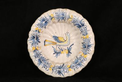 a blue and yellow plate with a bird on it