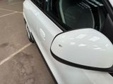 a white car that is parked in a parking lot