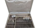 a silver tray with silverware in it on a white background