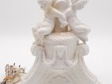 a white table lamp with two cherenshes on it