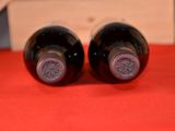two bottles of wine that are sitting on a table
