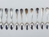 many spoons and spoon spoons lined up on a table
