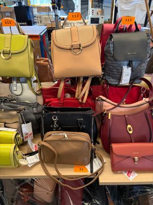 a lot of purses on a table in a store