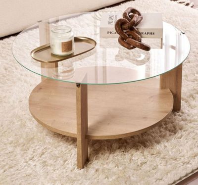 a coffee table with a glass top sitting on a rug