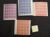 four different colored stamps on a black surface with a post - it note