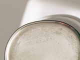 a close up of a glass object on a white surface