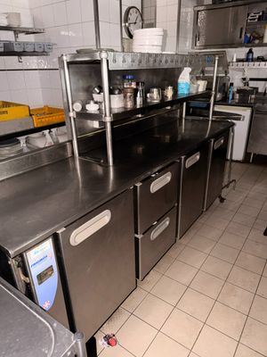 a kitchen with a lot of stainless steel counter tops