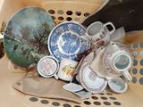 a basket full of tea cups and saucers in it