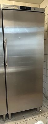 a large stainless steel refrigerator in a kitchen with a box on the floor