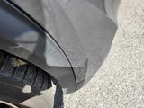 a close up view of a car ' s front bumper and tire