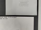 three envelopes with handwritten letters on them sitting on top of a table