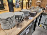 many plates and glasses on the counter in the store