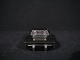 a toy car that is sitting on a black surface