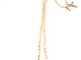 the necklace is made of pearls and a gold chain with a bird on it
