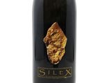 a close up of a bottle of wine on a white background