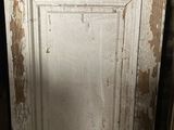 a white door with peeling paint on it in a room