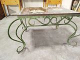 a table that has been painted green and has flowers on it