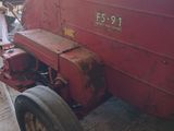 a red tractor that is parked in a garage
