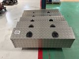 a metal box with four holes on it in a warehouse