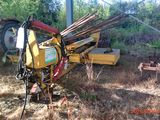 a tractor that is sitting in the grass with a plow