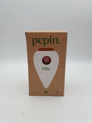 une boîte d'huile de pépin posée sur une surface blanche