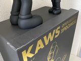 a statue of a man holding a soccer ball on top of a box