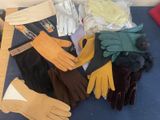 several pairs of gloves and gloves sitting on a blue surface