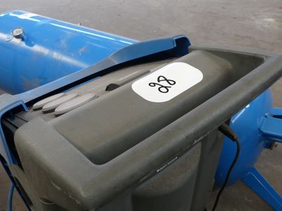a trash can with a sticker on it sitting in a parking lot