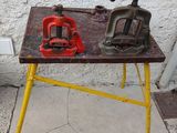two vises on a workbench on the sidewalk