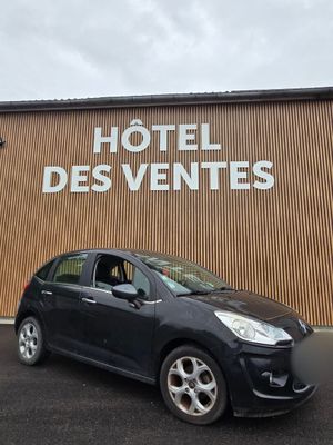 a black car parked in front of a building