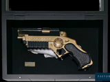 a gold and black toy gun in a black case