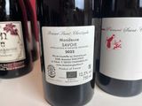 three bottles of wine are lined up on a table