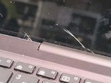 a close up of a broken laptop keyboard with a broken screen