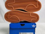 adidas shoes in a blue box on a white background